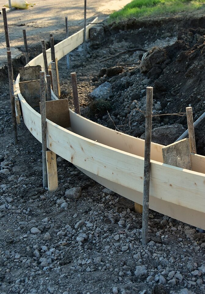 Wood forms installed ready for concrete pour for new curb and gu
